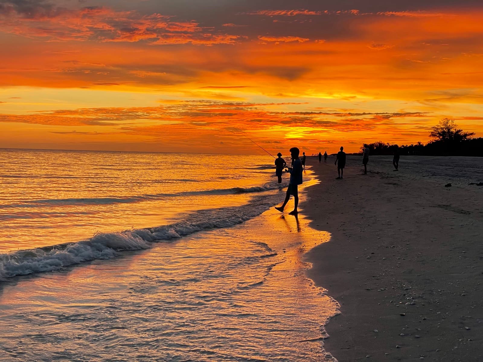 Sanibel Island sunset with silhouetted fisherman
