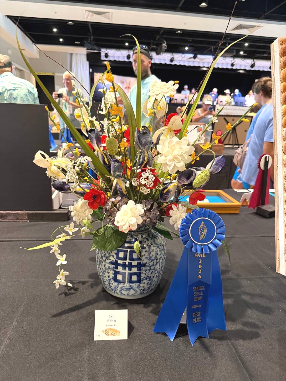 Shell flower arrangement in blue and white vase — first place, Barb Walling, Sanibel FL